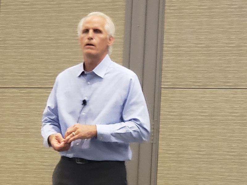 Tall white-haired in long-sleeved blue shirt speaking at the BOMA International Conference