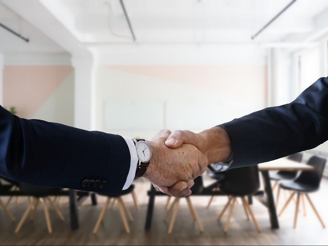 Shaking hands in office setting