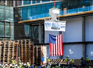 Clark Construction raises celebratory concrete bucket signed by workers who are building HQ2