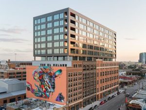 Office building in Deep Ellum with collage style mural by street artist Tristan Eaton 