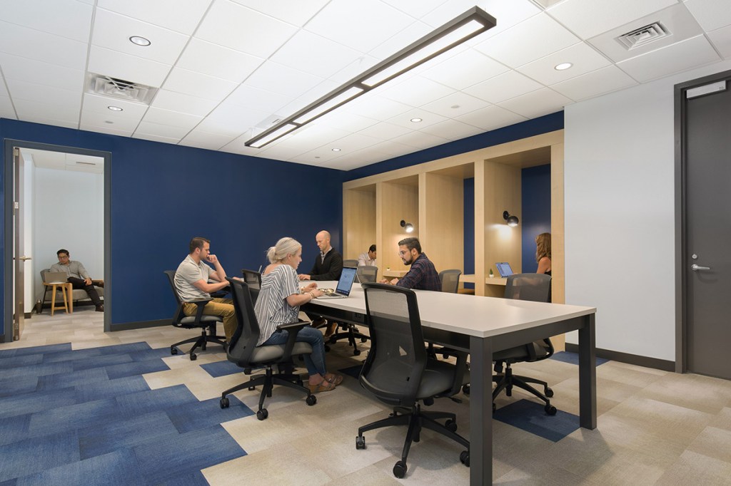 Workbar has several locations in the Boston area, including in Woburn, Mass. (right). Collaborative spaces are key to the design of the company’s coworking properties. Image courtesy of Workbar