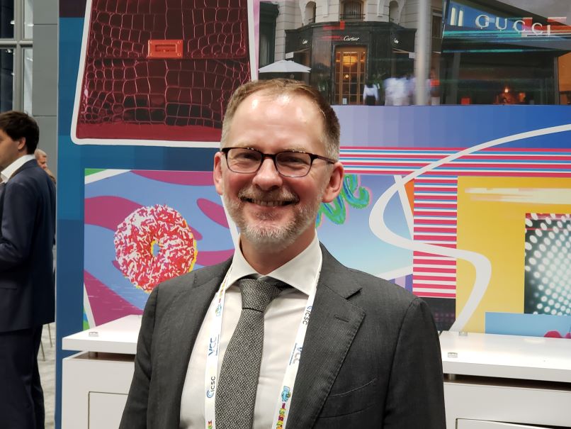 Photo of Brandon Isner smiling at Newmark's booth during ICSC's New York City show