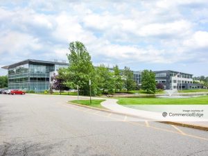 Exterior shot of 8 Sylvan Way, an office building in Parsippany, N.J. The image shows the facade and trees in front of the building