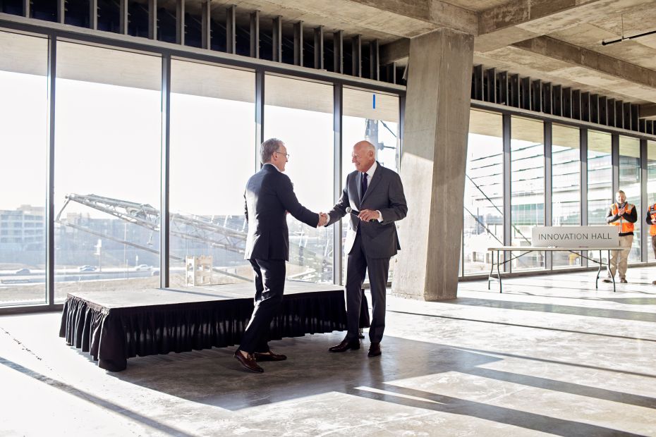 Two people shaking hands. Mark Beffort, CEO of Robinson Park, and Richard Tanenbaum, CEO of Gardner Tanenbaum at the topping off ceremony of Convergence Innovation District
