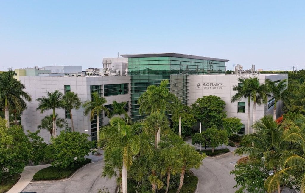 A building surrounded by palm trees, representing the life sciences and tech ecosystem in Palm Beach County.