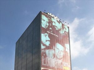Exterior shot of the 16-story building at 9000 W Sunset Blvd. in West Hollywood, Calif. The building features a 12-story HBO billboard.