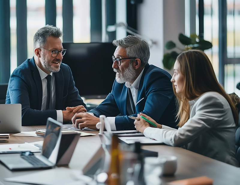 Three generations of investors sitting around a conference table
