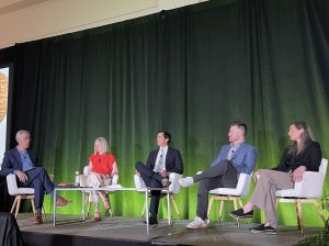 A photo of Craig Halpern of the IMA Corp. moderating the panel discussion with Jill Sherman of Edlen & Co., Redbrick LMD's Sohael Chowfla, Brian Earle and Kathy Berg of ZGF Architects.
