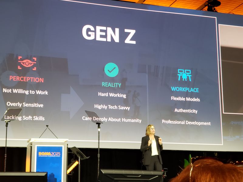Oversized projected sign with Gen Z at top, woman standing in front
