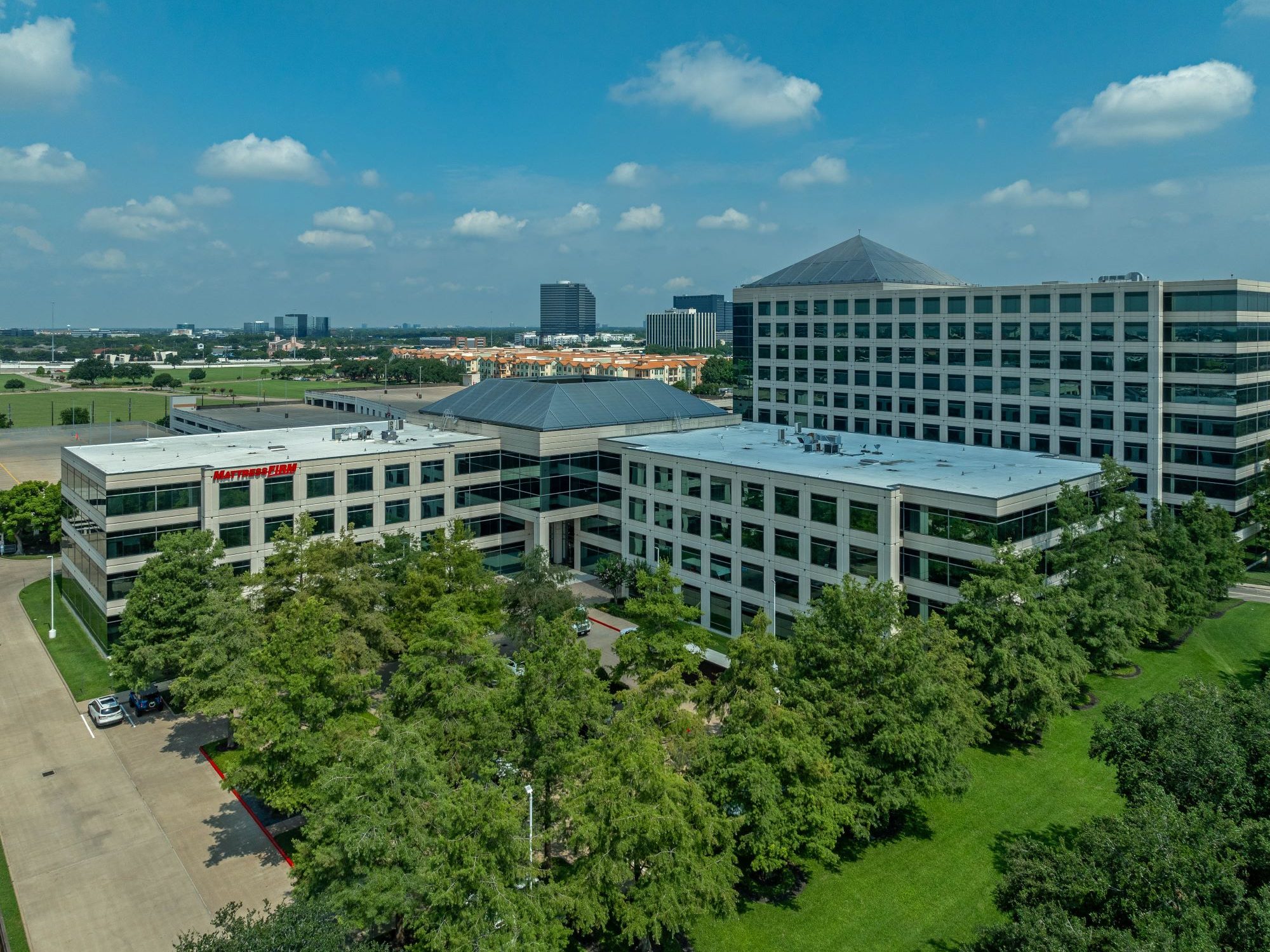 Exterior shot of the four-story office building Reserve at Westchase in Houston