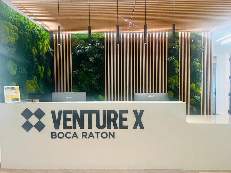 Interior shot of the front desk at Venture X's 30,000-square-foot coworking location at Palmetto Central Office Campus in Boca Raton, Fla.