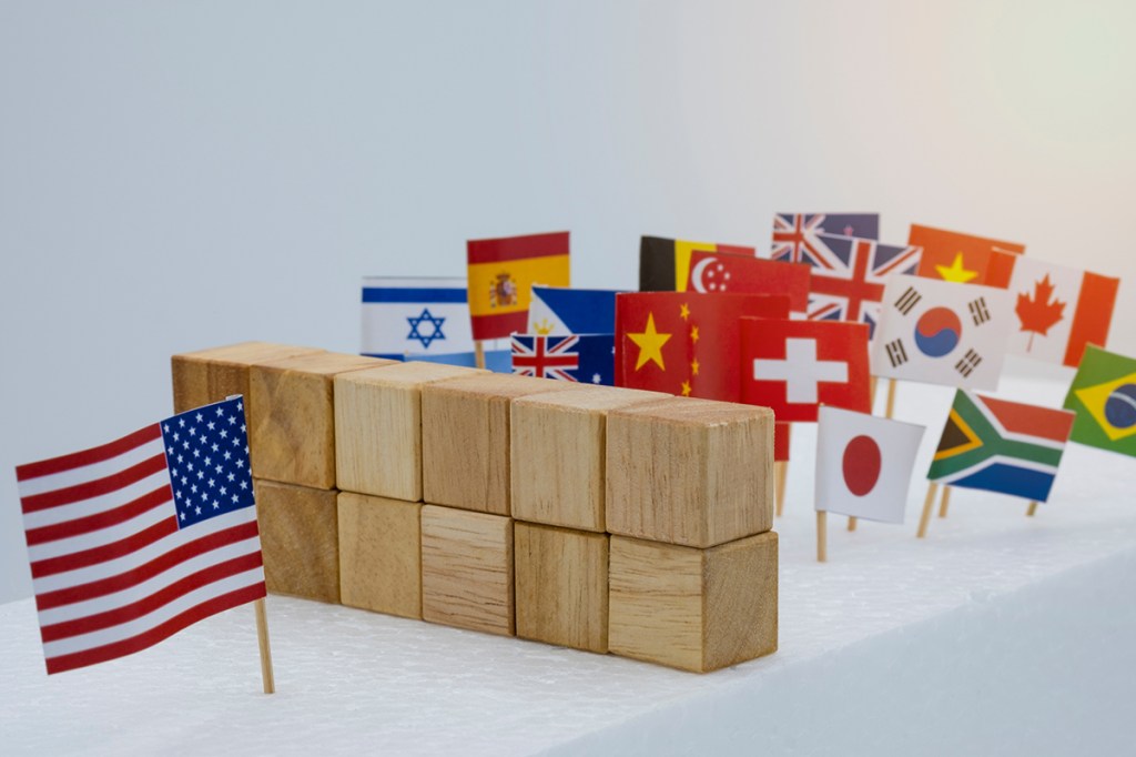 USA China and multi countries flags with wooden fence. It is symbol of America first policy and tariff trade war.