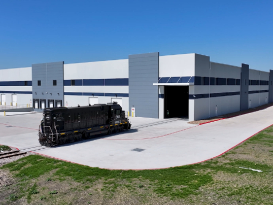 Exterior shot depicting the railway entry of Manulife's latest acquisition in Texas, a facility fully leased by Tesla.