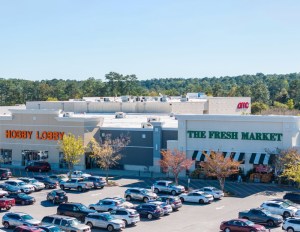 An overhead photo of Jubilee Square, with Hobby Lobby and The Fresh Market visible in the foreground and AMC Theatres behind.