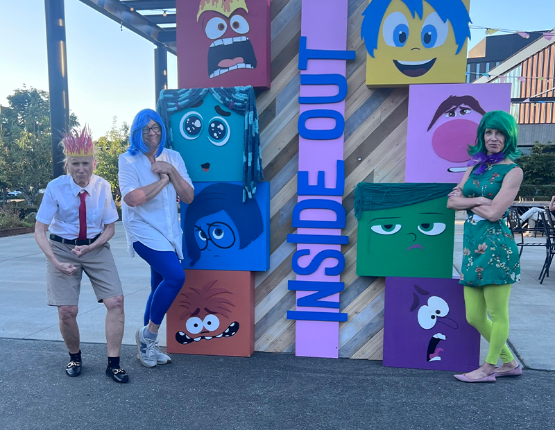 People dressed as inside-out characters for an outdoor movie night inThe Spring District