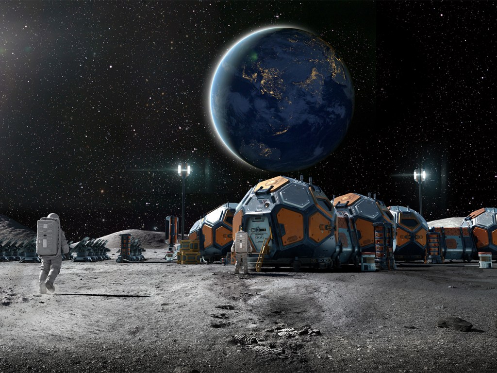Rear view of an astronaut near some foreground rocks walking towards a lunar base camp made from group of linked habitation pods, solar panels and equipment.