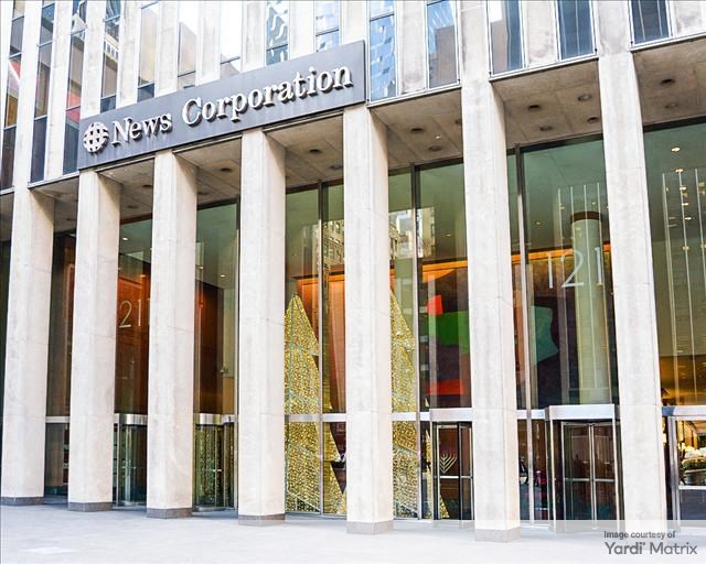 The exterior of the lobby of 1211 Avenue of the Americas, highlighting it as the headquarters of News Corp.