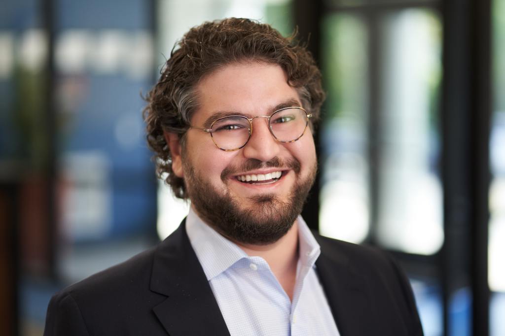 A headshot of David Greek.