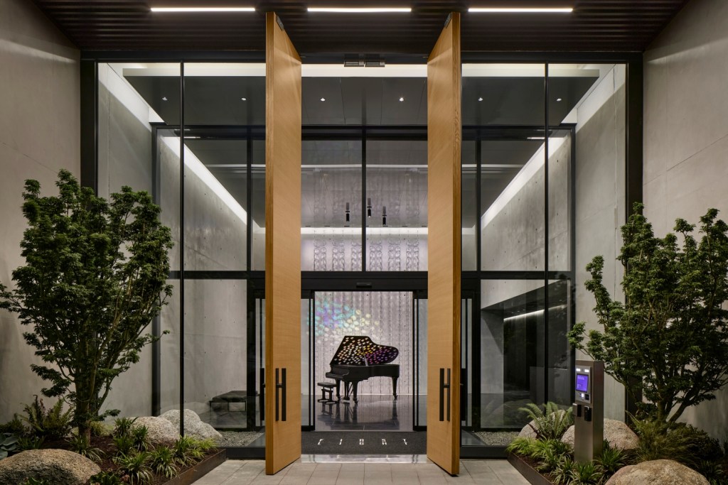 Stylish entrance of a modern lobby with a grand piano positioned elegantly, highlighting a blend of music and architecture
