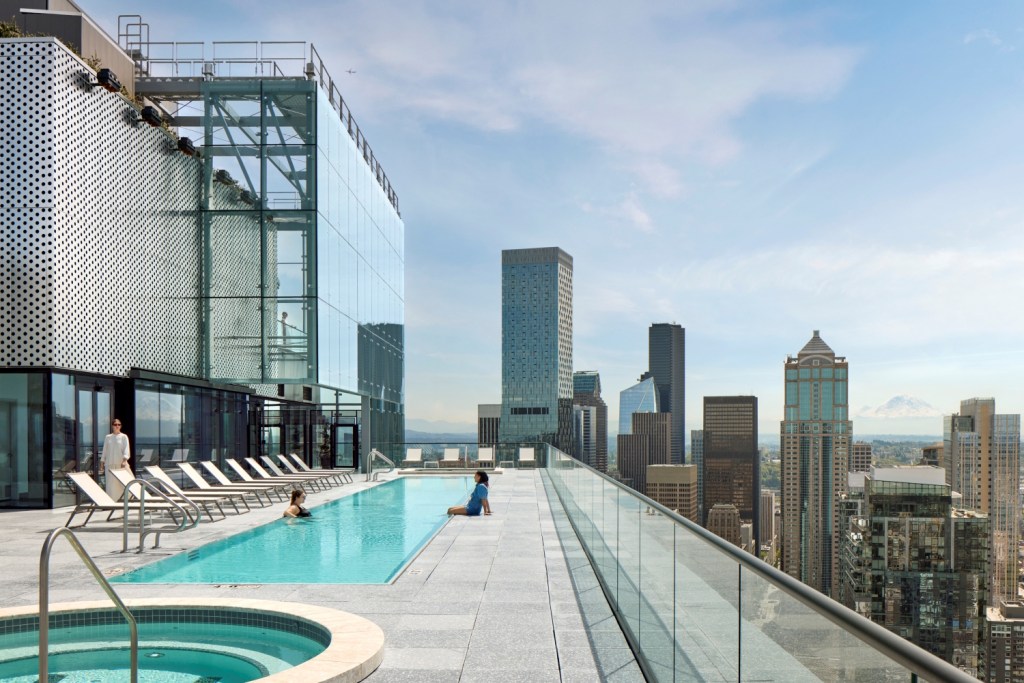 First Light's 47th floor pool, offering panoramic views of the city and inviting lounge spaces for guests.