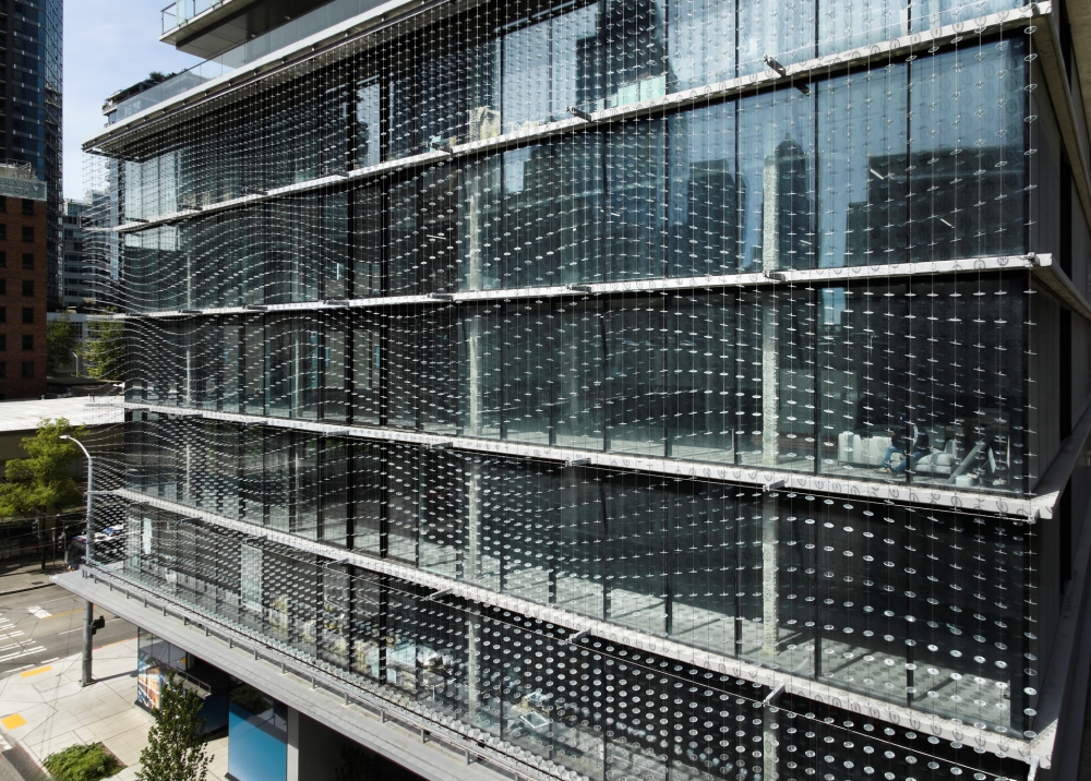 The Veil is a striking large-scale glass artwork by John Hogan, seamlessly integrated into the architecture of the downtown Seattle project.