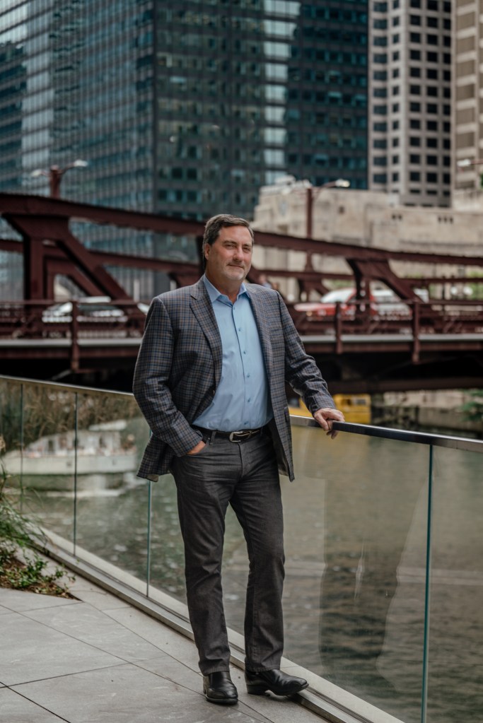 Mark Rose CEO of Avison Young in front of a bridge.