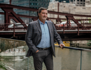 Mark Rose CEO of Avison Young in front of a bridge.