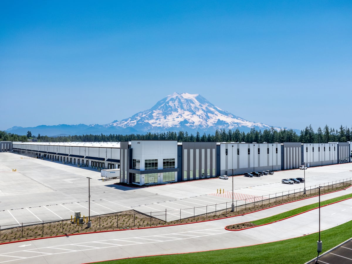 A photo of 6920 192nd St., showing a distribution facility with Mount Rainier in the distance behind.