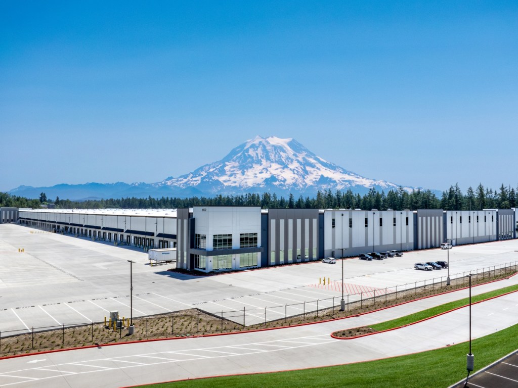 A photo of 6920 192nd St., showing a distribution facility with Mount Rainier in the distance behind.