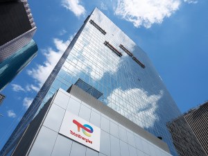 A ground-level photo looking up at TotalEnergies Tower in Houston.