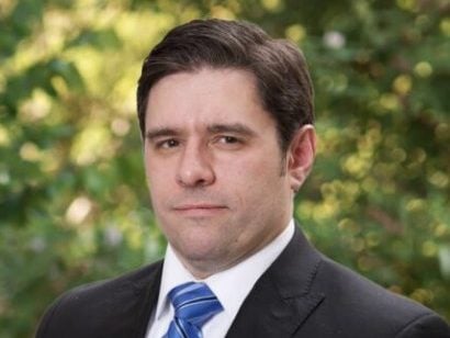 A headshot photo of Justin Lia, President of Pond Robinson & Associates.