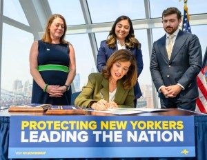 A photo of New York Governor Kathy Hochul signing a moratorium on hyperscale data center development.