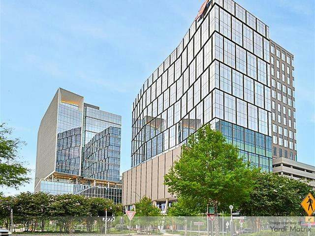 glass office building depicted in a landscaped park