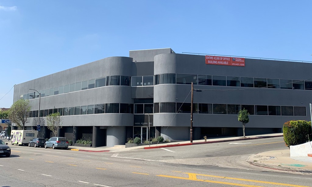 A two-story gray office building at 533 Glendale Blvd. in Los Angeles' Echo Park with a large "Office Building Available" sign, later leased for conversion into an educational campus.