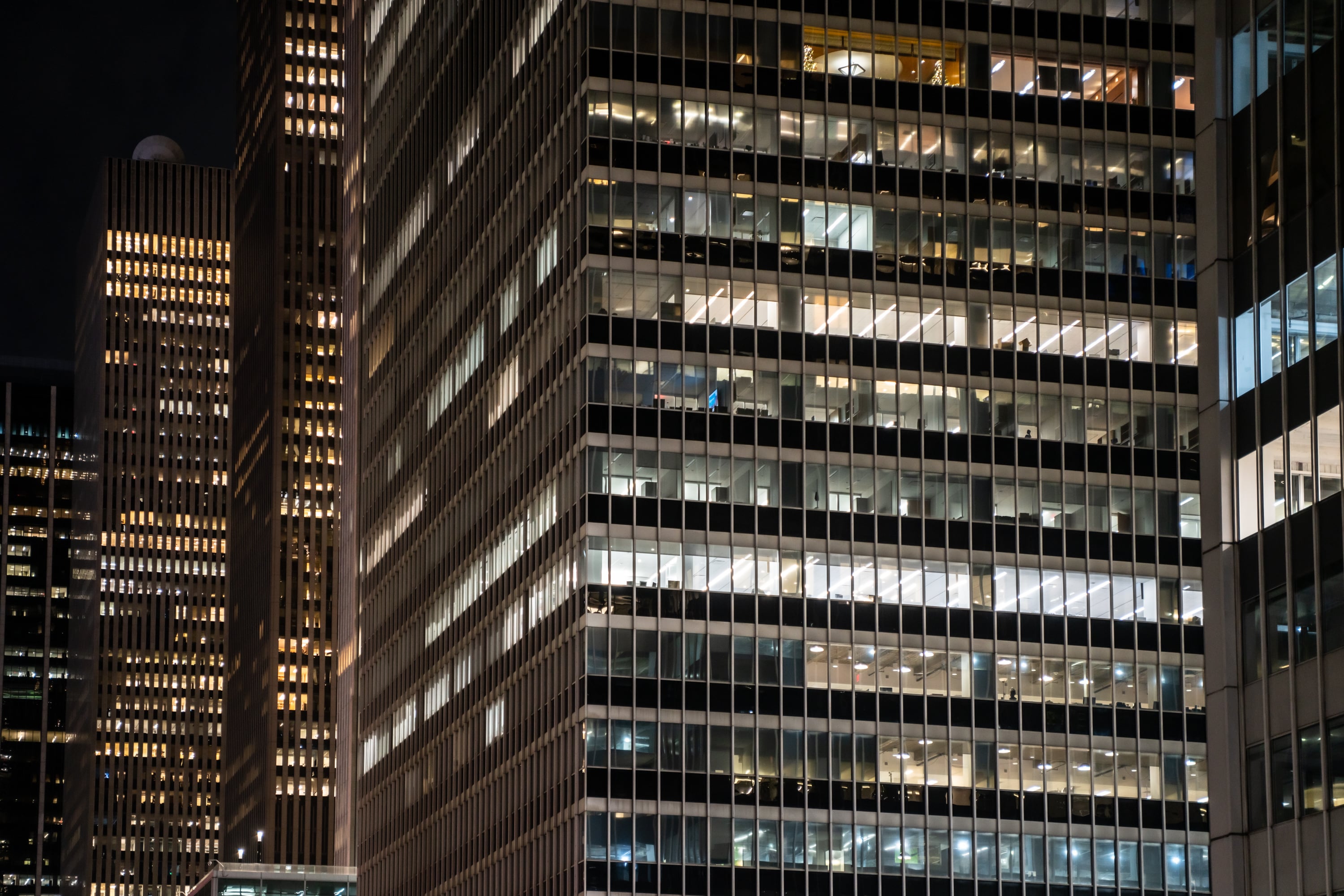 Exterior shot of office buildings at night.
