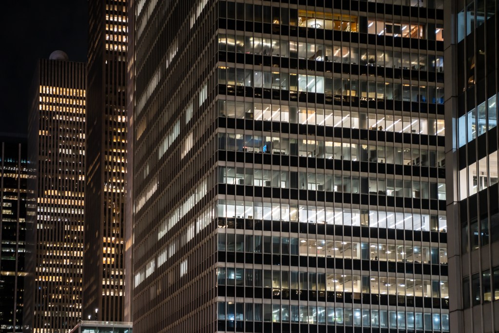 Exterior shot of office buildings at night.