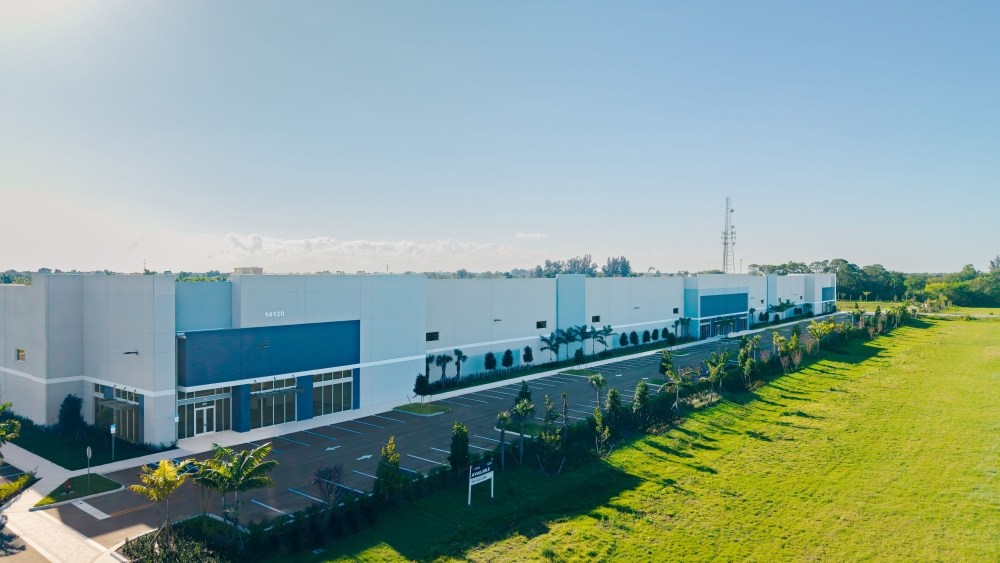 industrial buildings overlooking a green field